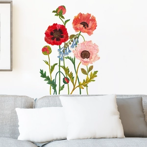 Pink poppy floral wall stickers above a gray sofa for modern living room decor