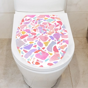 Close-up of a colorful terrazzo stone pattern sticker applied on a white toilet lid