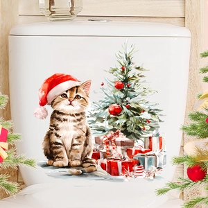 Adesivo natalizio con gatto e albero applicato su una cassetta WC in ceramica bianca