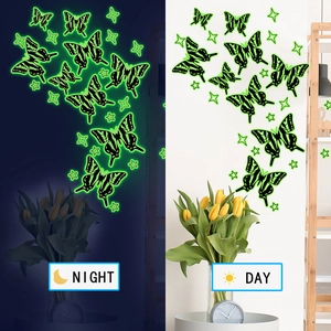 Luminous green butterfly and star wall decals showing day and night glow effect
