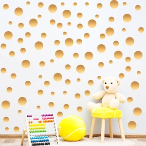 Golden round polka dot wall decals in various sizes for minimalist nursery and home decor