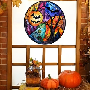 Detail of round Halloween stained glass sticker with pumpkin castle and bat on wooden window