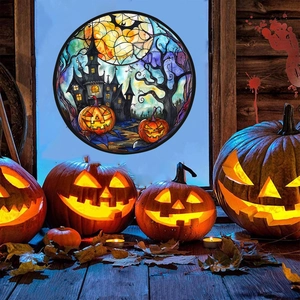 Detail of Halloween window cling showing a spooky castle, pumpkins, and bats on glass