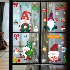 Detail of Christmas window clings featuring gnomes, snowmen, and festive snowflakes