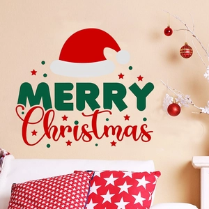 Detail view of Merry Christmas wall decal with Santa hat on a cozy living room wall