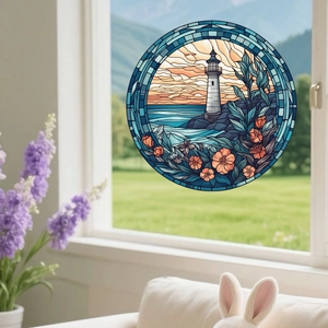Macro detail of a round stained glass window cling featuring a lighthouse and ocean scene