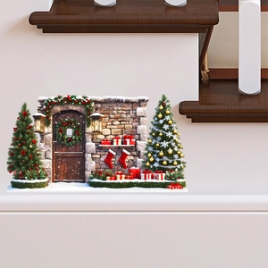 Close-up of festive Christmas wall stickers featuring snow-covered stone walls and a wooden door