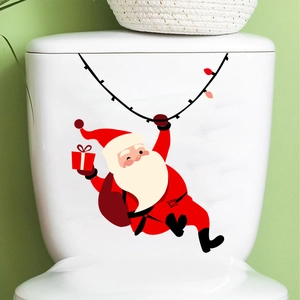 Detail of Santa Claus cartoon sticker with gift bag applied on a white toilet tank