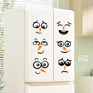 Detail view of 6 DIY snowman face stickers for refrigerator decoration on a white fridge