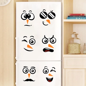Detailed view of six cute cartoon snowman face stickers applied on a white refrigerator