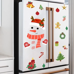 Detailed view of festive snowman and Christmas icons stickers on a white refrigerator