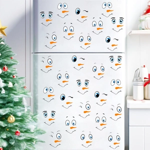 DIY Christmas snowman face stickers for fridge decoration featuring carrot nose and blue eyes
