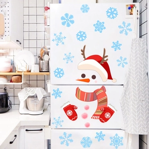 Christmas snowman fridge decals with snowflakes and red accessories on a white kitchen fridge