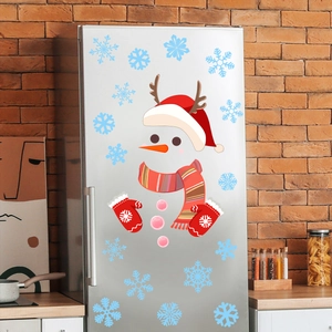 Close-up of cute snowman fridge decals on a silver refrigerator with festive kitchen background