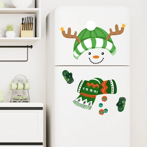 Detailed view of colorful snowman face stickers with green striped hat on white fridge