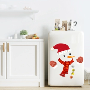 Close-up of PVC snowman fridge stickers with red hat and scarf on a white surface