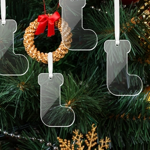 Clear acrylic Christmas stocking ornament hanging on green tree branches for DIY decor
