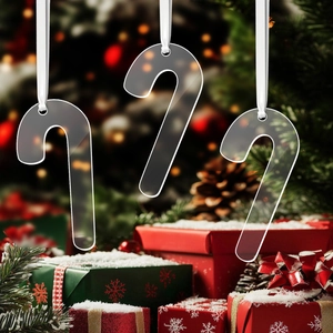 Three transparent acrylic candy cane ornaments hanging with white satin ribbons
