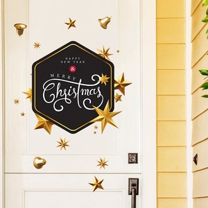 Macro detail of Merry Christmas door stickers with golden 3D stars on a white door background