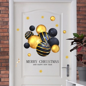 Detail of Christmas door sticker featuring black gold ornaments and holiday greetings