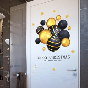 Detail of black and gold Christmas door stickers with snowflakes and festive greetings