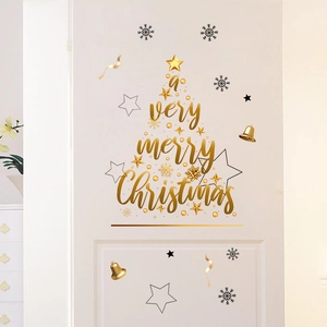 Detail of Christmas wall stickers featuring golden Merry Christmas lettering on a door