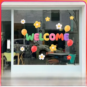 Detail of 3D Welcome sticker with colorful daisies and balloons on shop glass