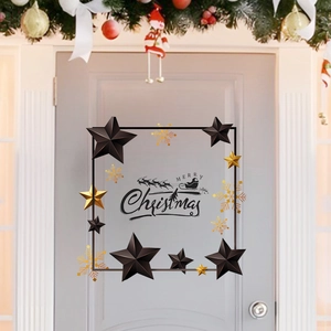 Close-up of black and gold stars with Merry Christmas wall stickers on a grey door