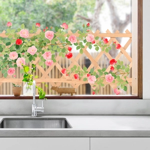 Detail view of decorative flower wall stickers with pink roses on kitchen window glass