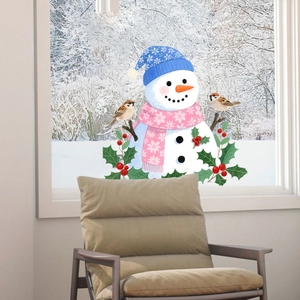Detail of Christmas snowman window sticker with blue hat and pink scarf on glass