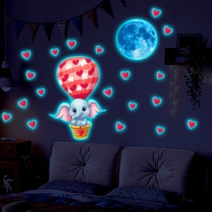 Glow in the dark wall stickers showing elephant in hot air balloon and blue moon in kids room