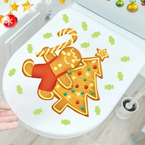 Glow-in-the-dark Christmas gingerbread man and tree wall sticker on a white toilet lid