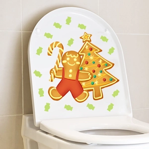 Glow in the dark Christmas gingerbread man and tree sticker applied on a white toilet cover