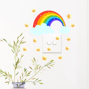 Close-up of rainbow and smiling star wall decals applied on a clean white wall