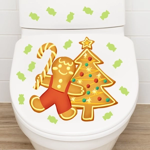 Detail of Christmas toilet lid decals with gingerbread man and tree stickers