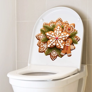 Detailed view of Christmas gingerbread and pine branch decals on white toilet lid