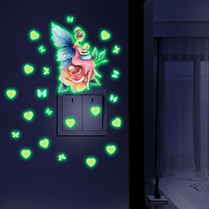 Luminous wall stickers showing fairy and butterflies glowing in the dark near switch