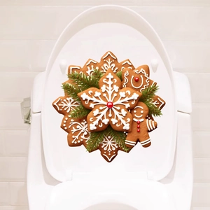 Detail of 3D Christmas gingerbread and snowflake stickers on white toilet lid surface