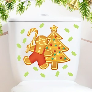 Detailed close-up of gingerbread man and Christmas tree wall stickers on a white surface