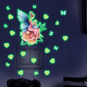 Luminous wall stickers showing fairy and butterflies glowing green in the dark