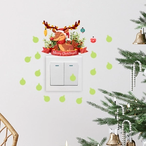 Detail of Christmas reindeer switch stickers with Merry Christmas banner on white wall