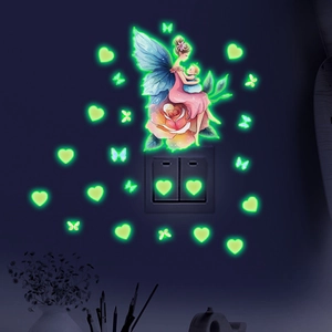 Luminous wall stickers featuring fairy, hearts and butterflies glowing green in the dark