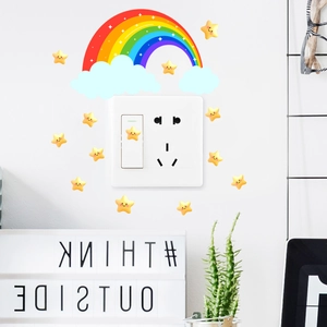 Detail view of colorful rainbow and smiling star wall stickers on a light switch panel