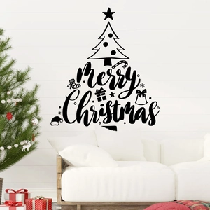 Detail of black vinyl Merry Christmas tree wall decal in a cozy bedroom setting