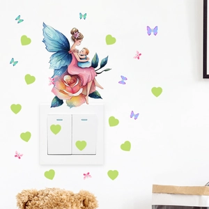 Detail of glow-in-the-dark fairy and butterfly wall sticker applied near a light switch