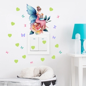Detailed view of fairy and butterfly glow stickers around a light switch in a nursery