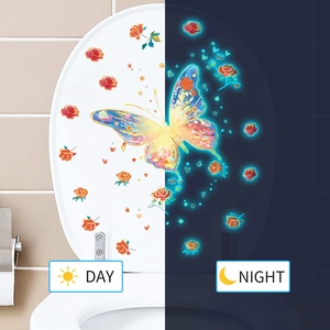 Glow-in-the-dark butterfly and rose toilet decal showing day and night fluorescence effects