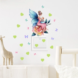 Detail of fairy and butterfly wall stickers applied around a light switch on a white wall