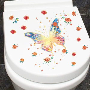 Detailed view of colorful butterfly and red roses decals on a white toilet lid surface