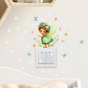 Detailed view of glowing cartoon fairy and butterfly wall stickers on white light switch